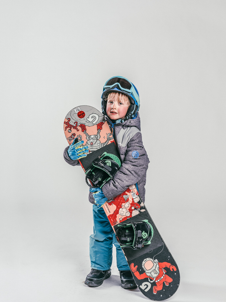 Oxygène Ski & Snowboard School Child Holding Snowboard 3